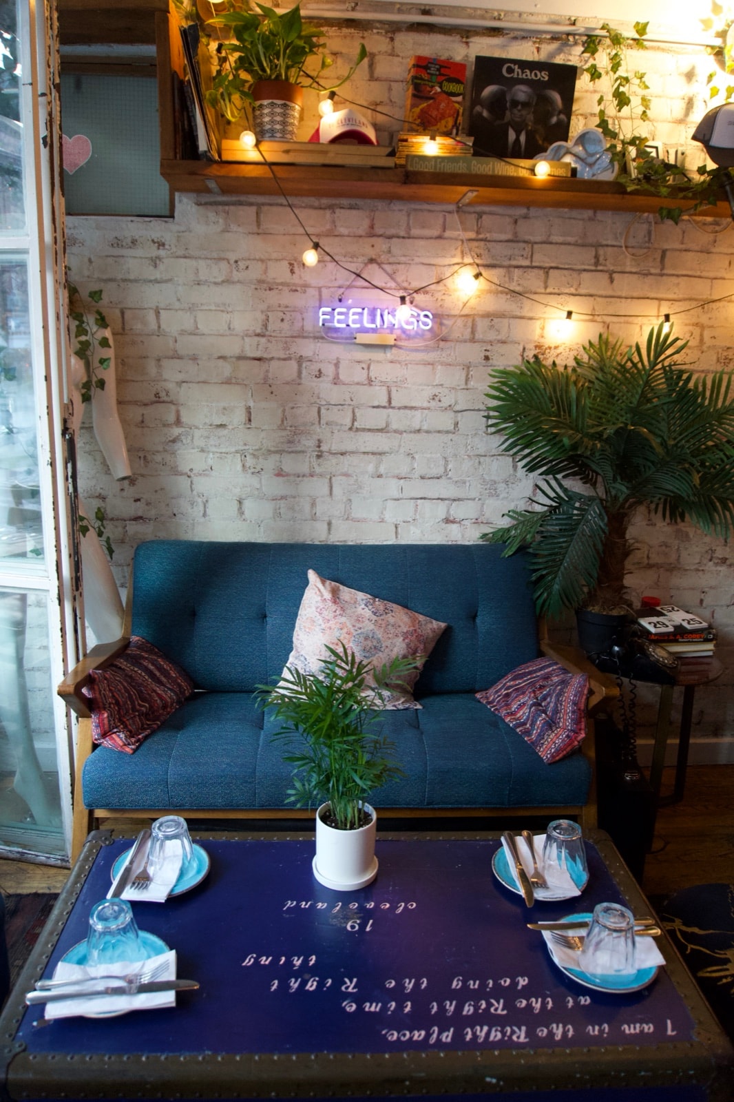 The blue sofa lounge corner at 19 Cleveland under string lights