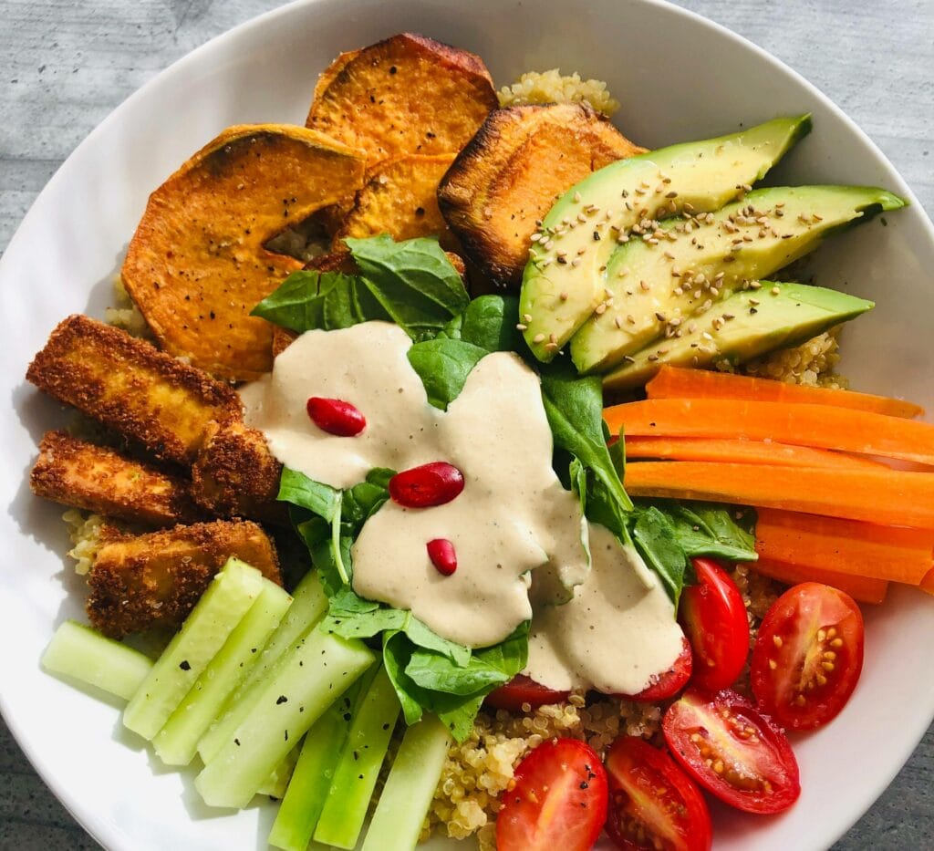 there is a bowl of food with vegetables and meat on it