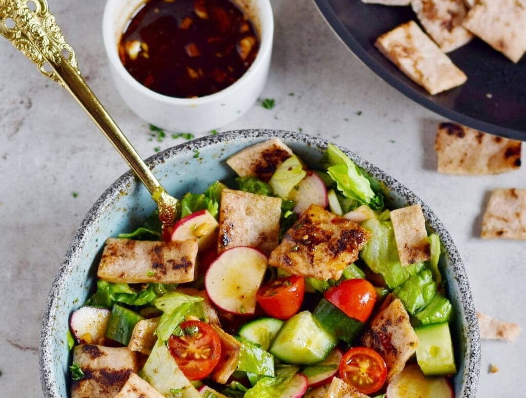 fattoush salad in bowl with spoon