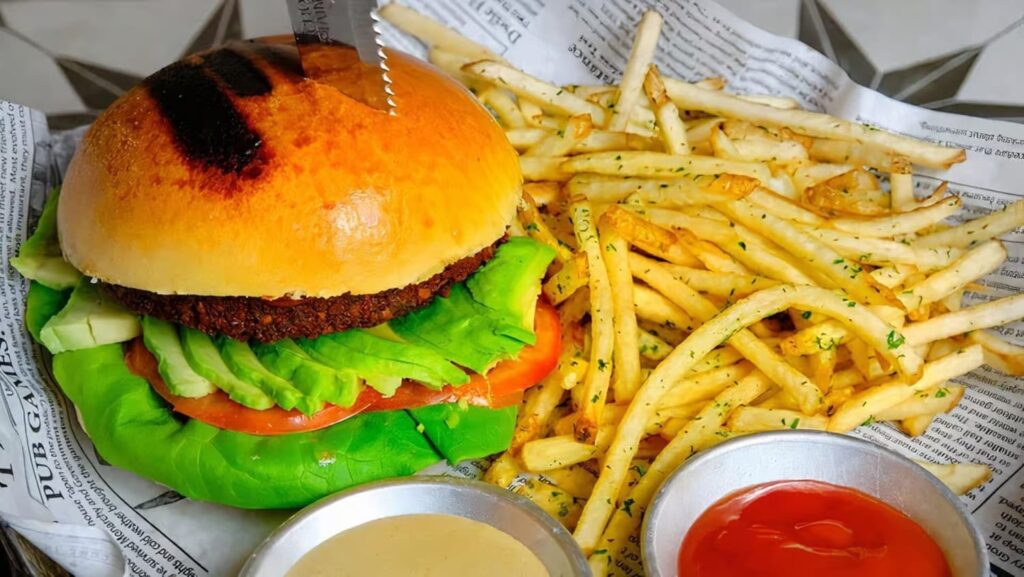 arafed burger and fries on a newspaper with ketchup