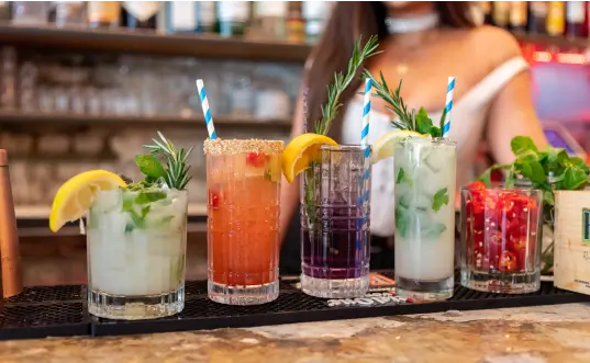 a close up of a bar with a variety of drinks on a bar