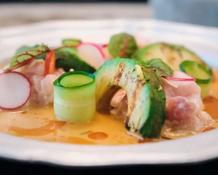 there is a plate of food with cucumbers and radishes on it