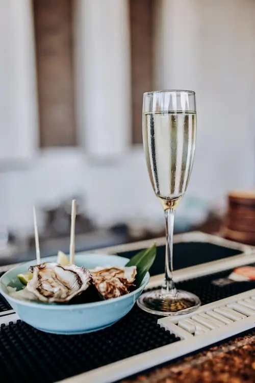 a close up of a plate of food with a glass of wine
