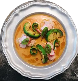 there is a bowl of soup with vegetables and meat in it