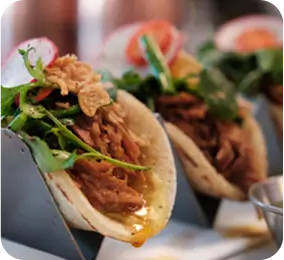 there are three tacos with meat and vegetables on a plate