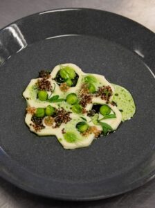 there is a plate of food with a green sauce on it