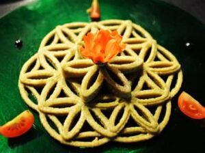 there is a green plate with a flower of life on it