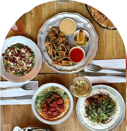there are many plates of food on the table with silverware