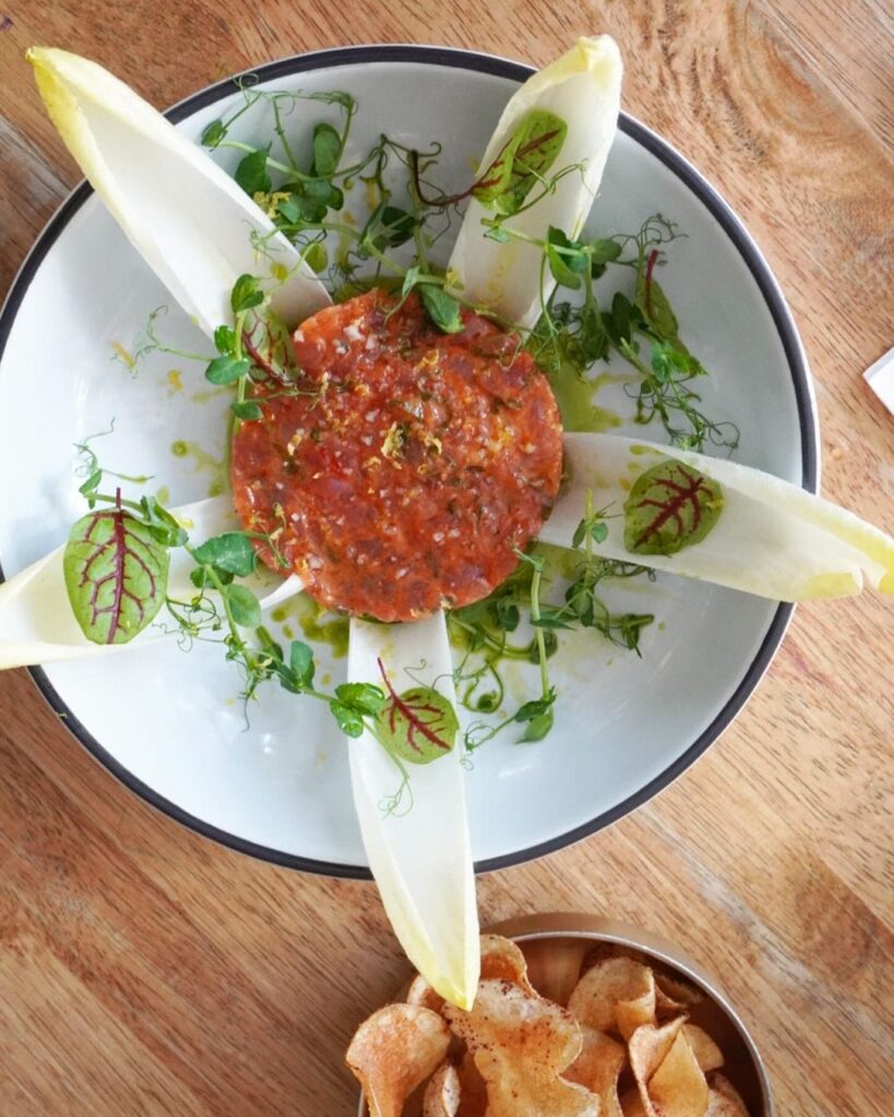 a close up of a plate of food with a salad on it