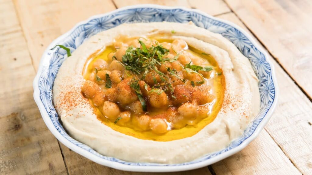 araffy hummus with chickpeas and herbs in a bowl