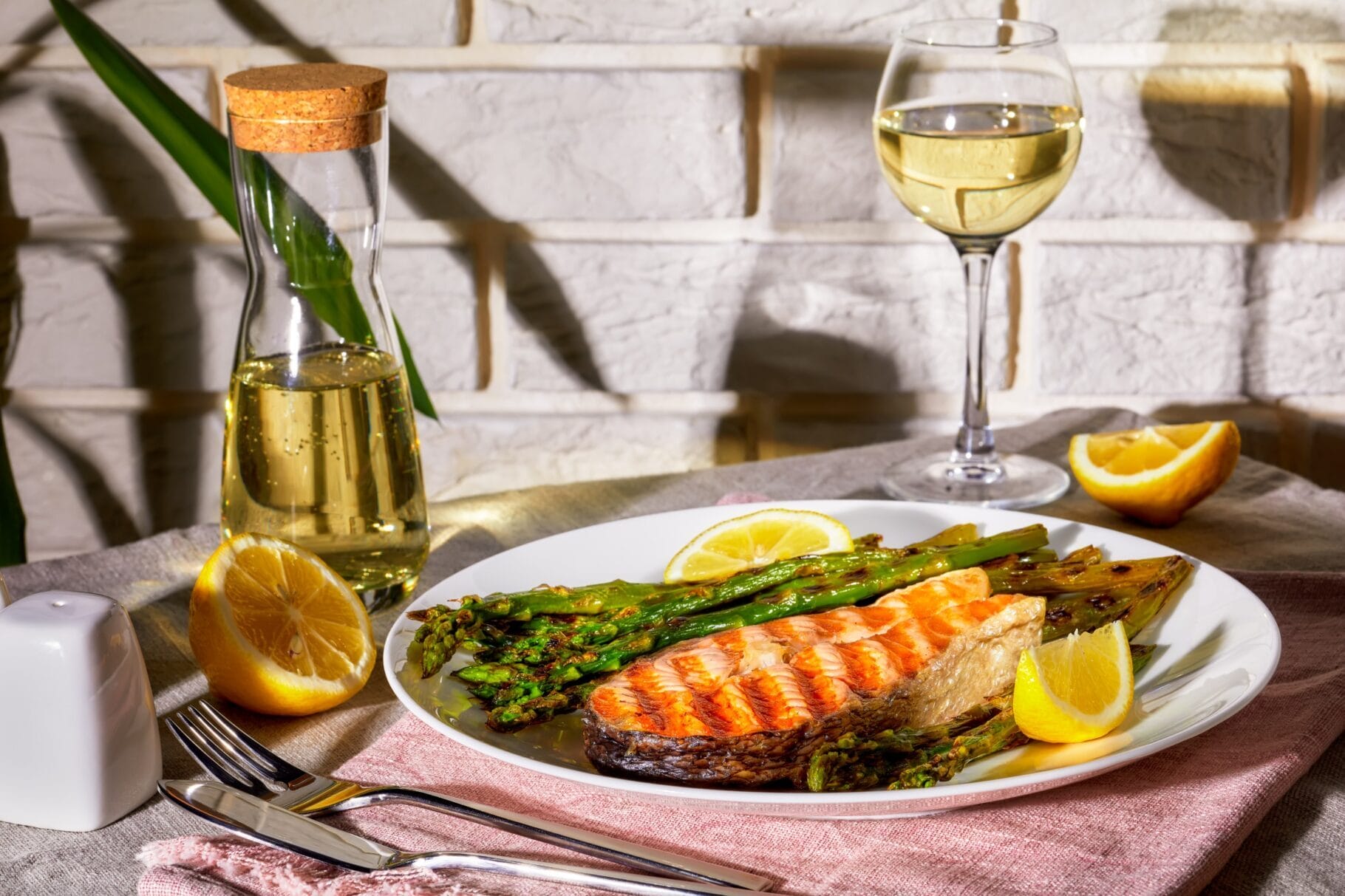 there is a plate of food with fish and asparagus on it