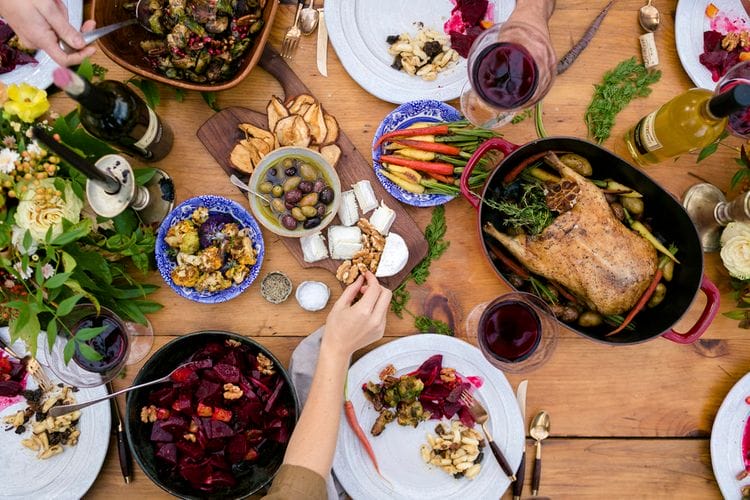 arafed table with a variety of food and wine glasses