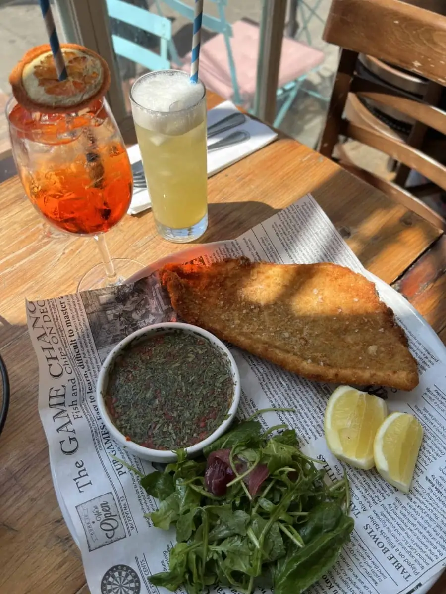 there is a plate of food on a table with a drink
