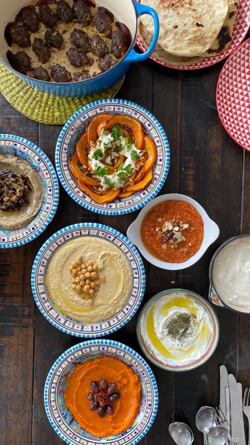 a close up of a table with plates of food and utensils