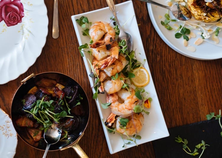 a close up of a plate of food with shrimp and vegetables