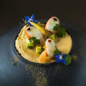 there is a plate with a small dish of food on it