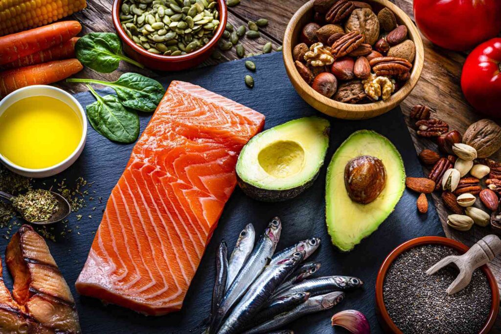 a close up of a variety of food including fish, nuts, avocado, and other