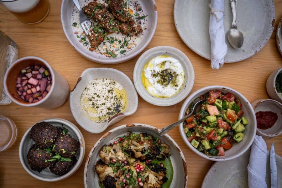 a close up of a table with bowls of food and utensils