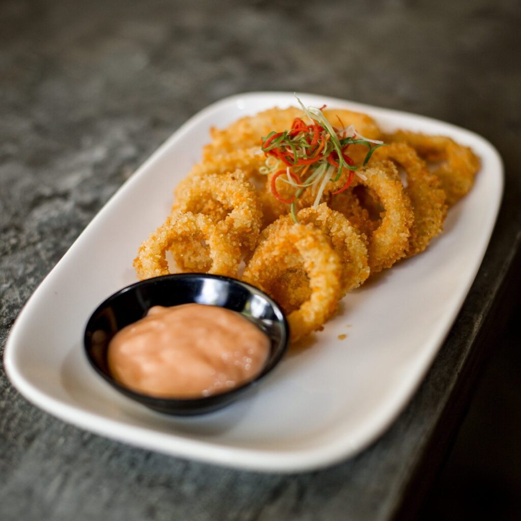 there is a plate of fried food with a dipping sauce