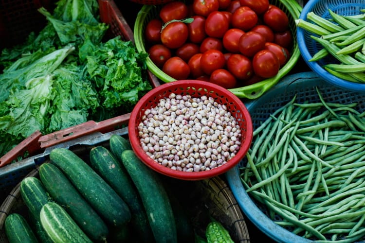 there are many different types of vegetables in baskets on the table