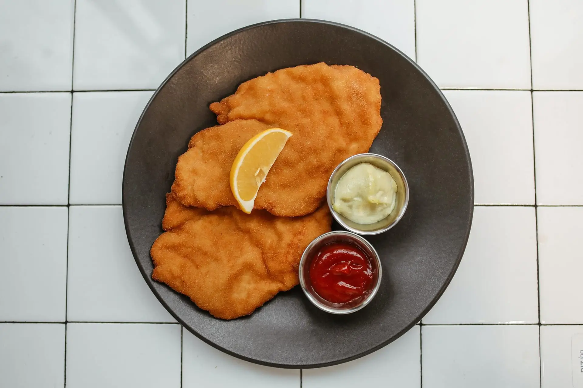 there is a plate of food with fish and sauces on it