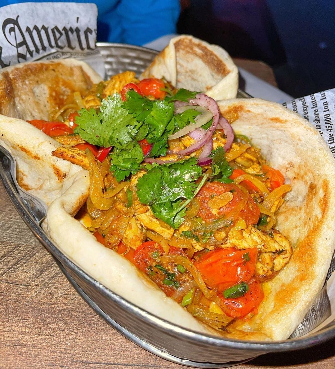 there is a plate of food with pita bread and vegetables