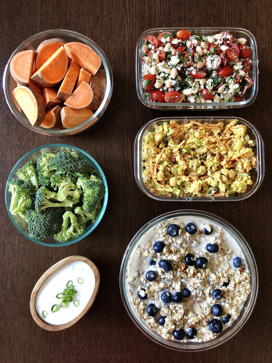 arafed meal in glass containers with vegetables and dips
