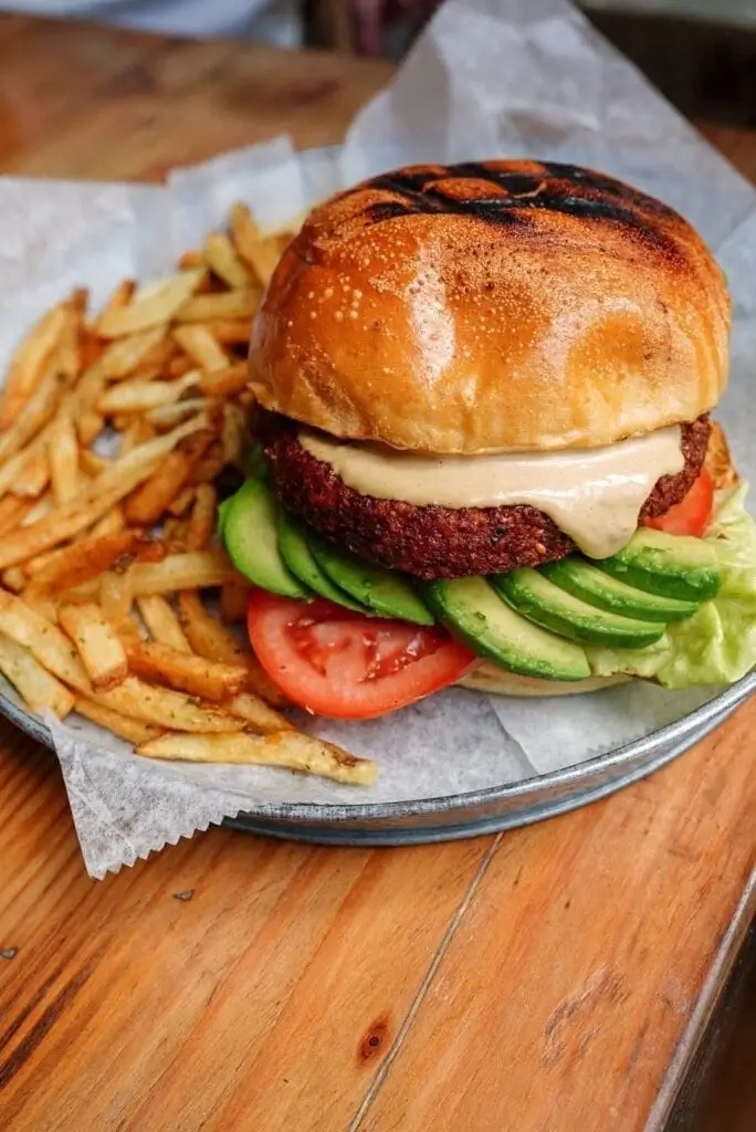 a close up of a burger and french fries on a plate