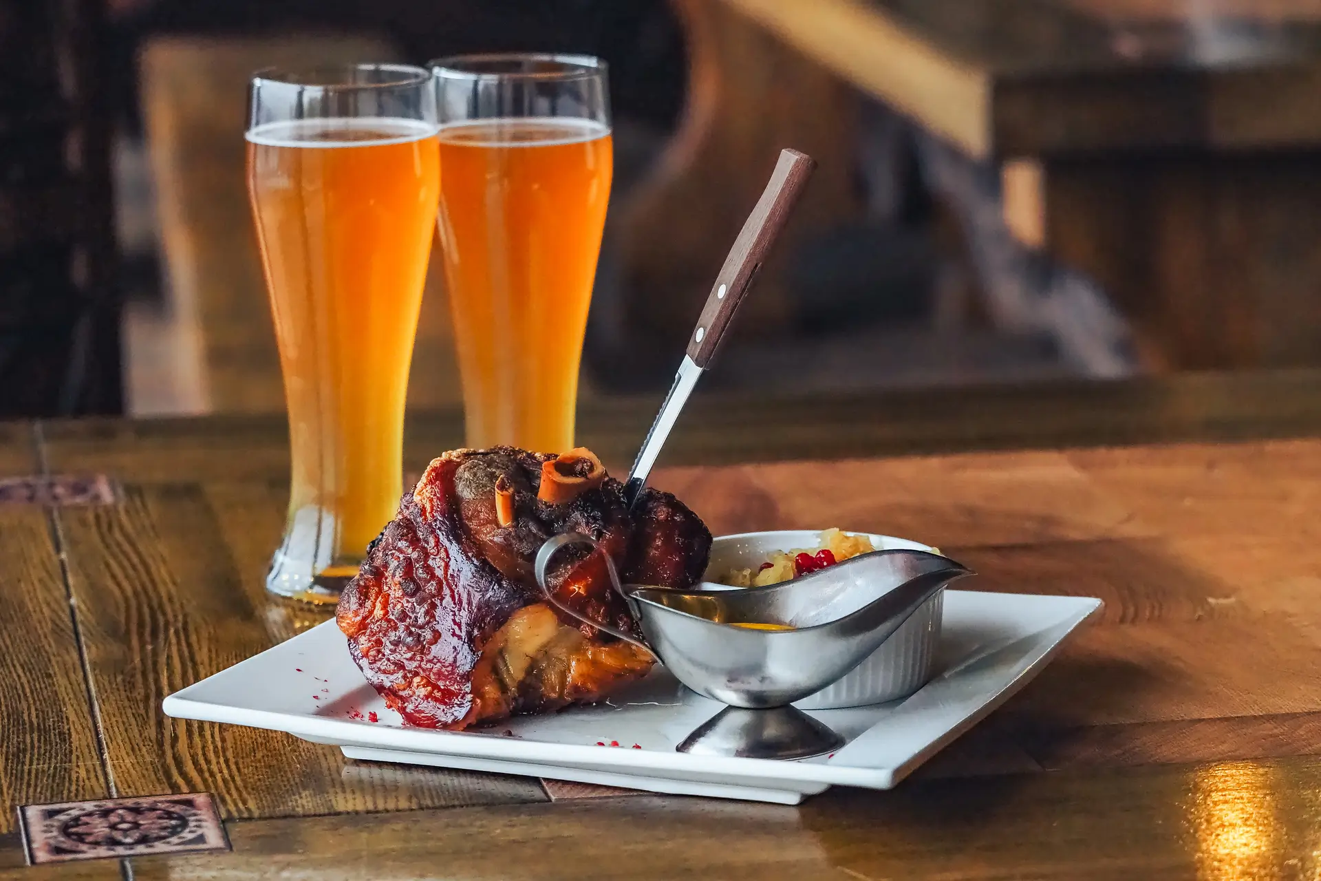 Roasted pork knuckle with gravy and two beers at 19 Cleveland