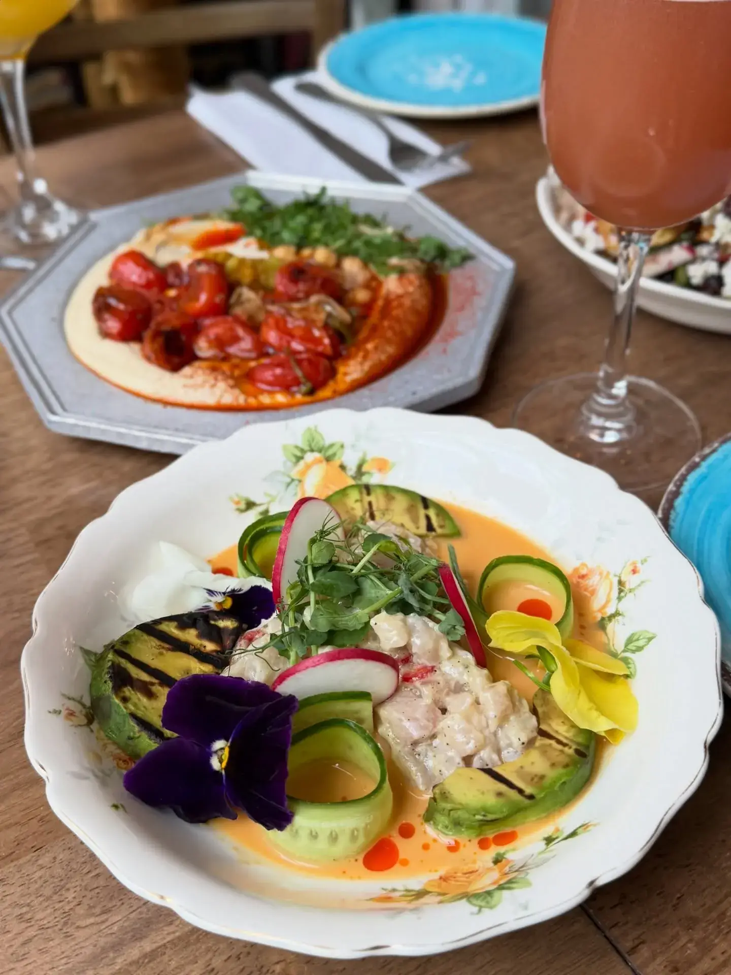 Outdoor or vibrant interior dining scene at 19 Cleveland with guests enjoying a meal.