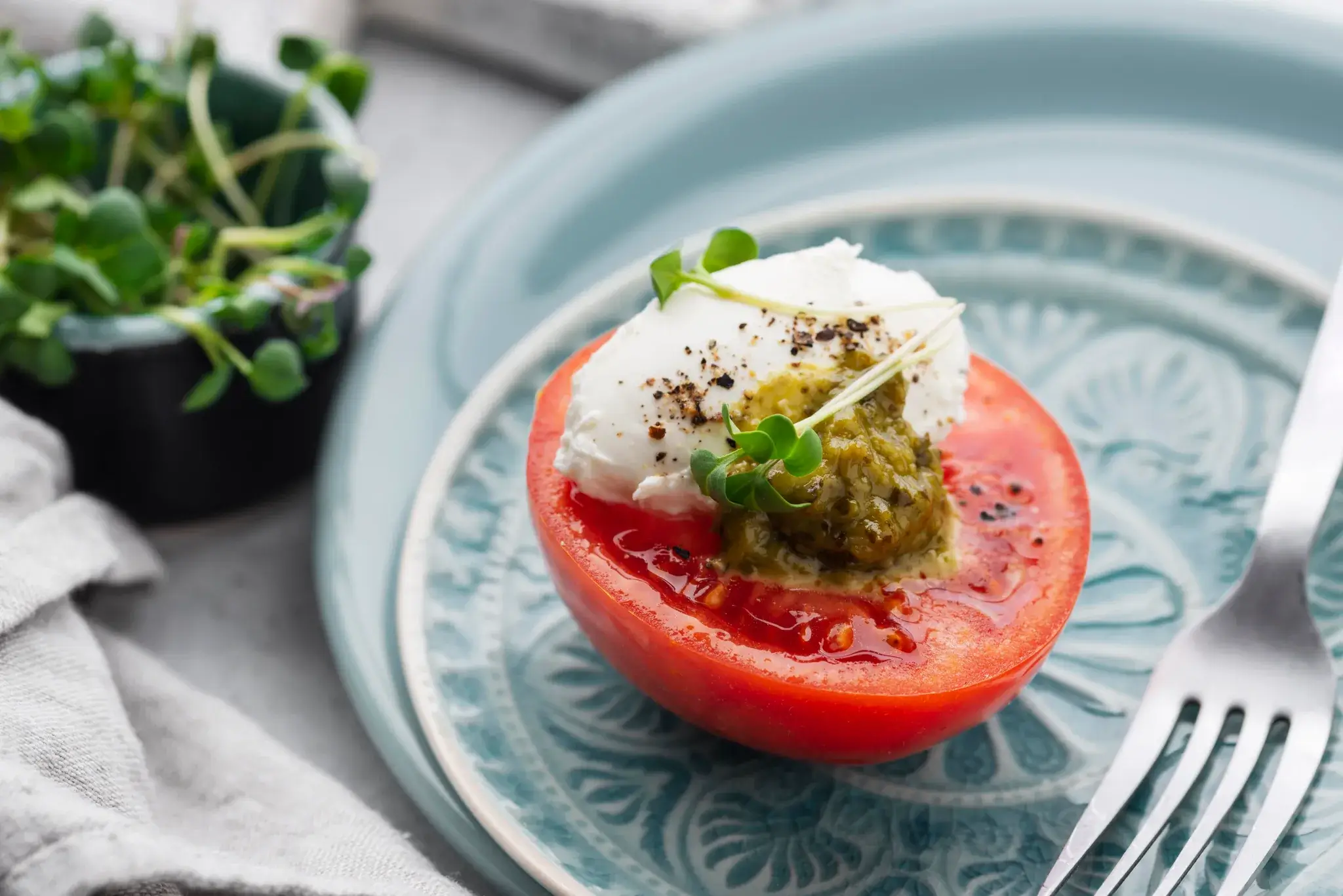 Close-up of burrata with cherry tomato jam and herbs