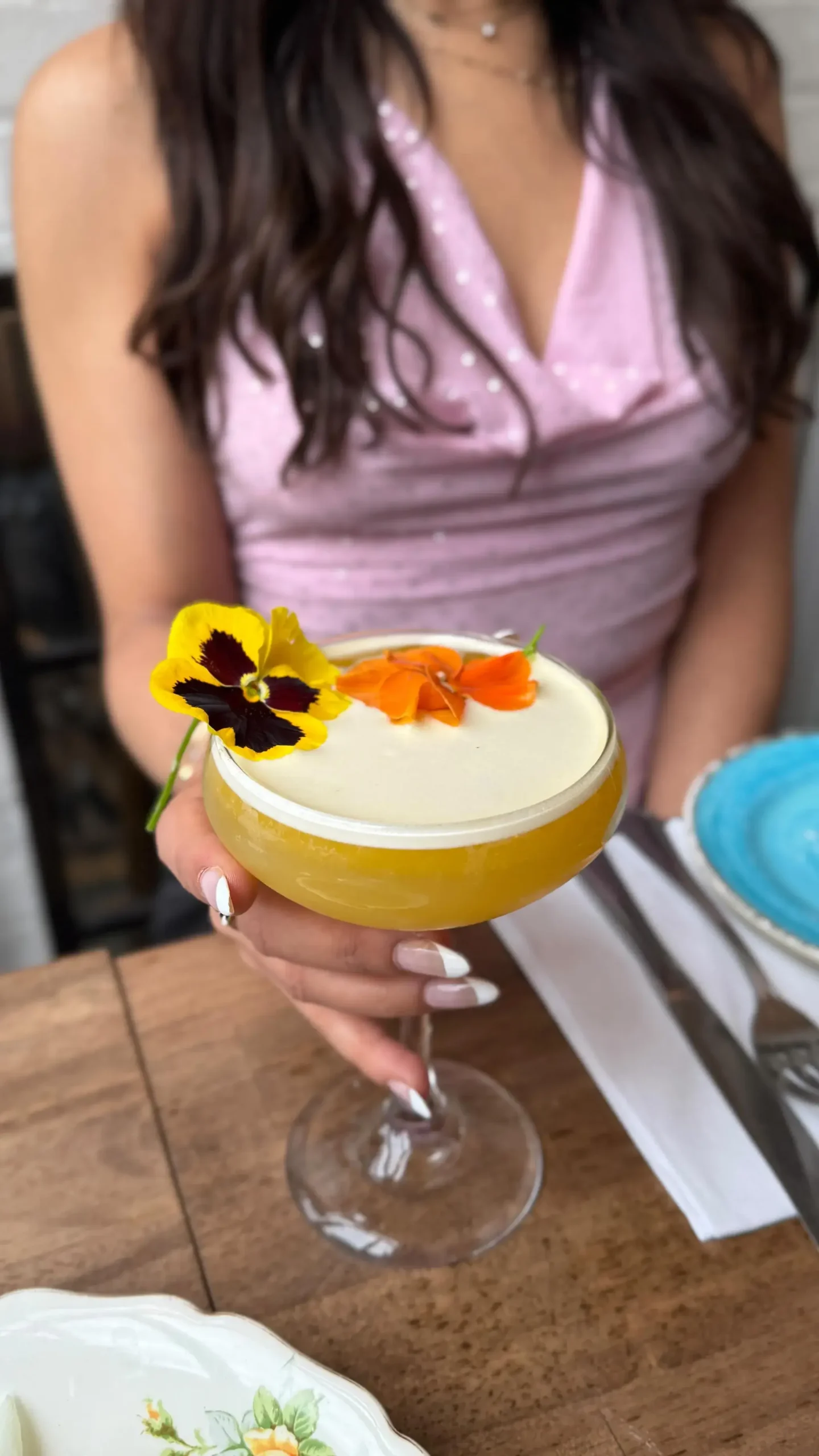 Passion fruit cocktail with edible flowers