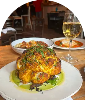 Roasted cauliflower with herbs, sauces, and white wine